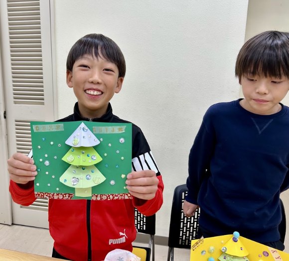 クリスマスのカードを持つ男の子たち